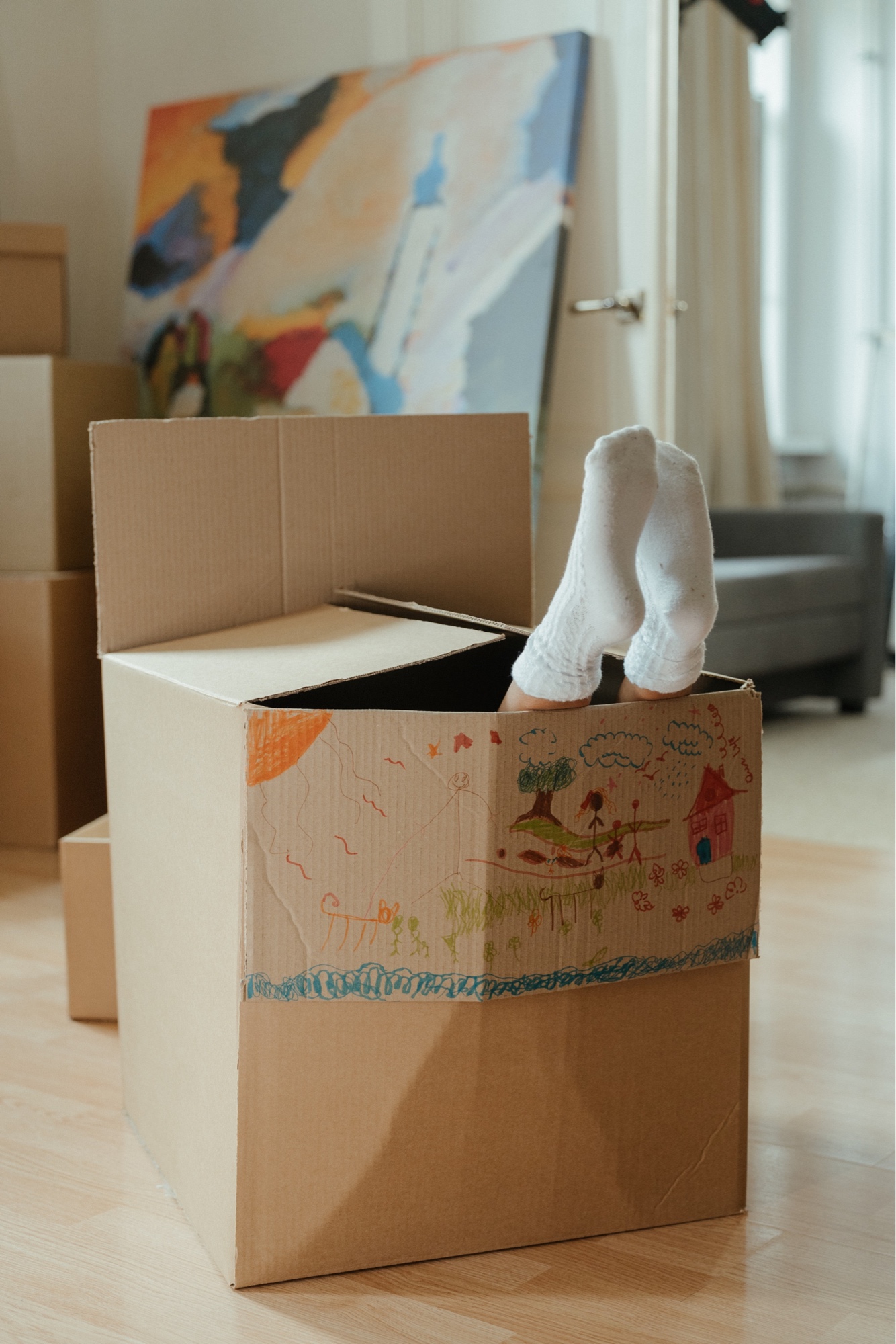 Child's feet sticking out of a moving box